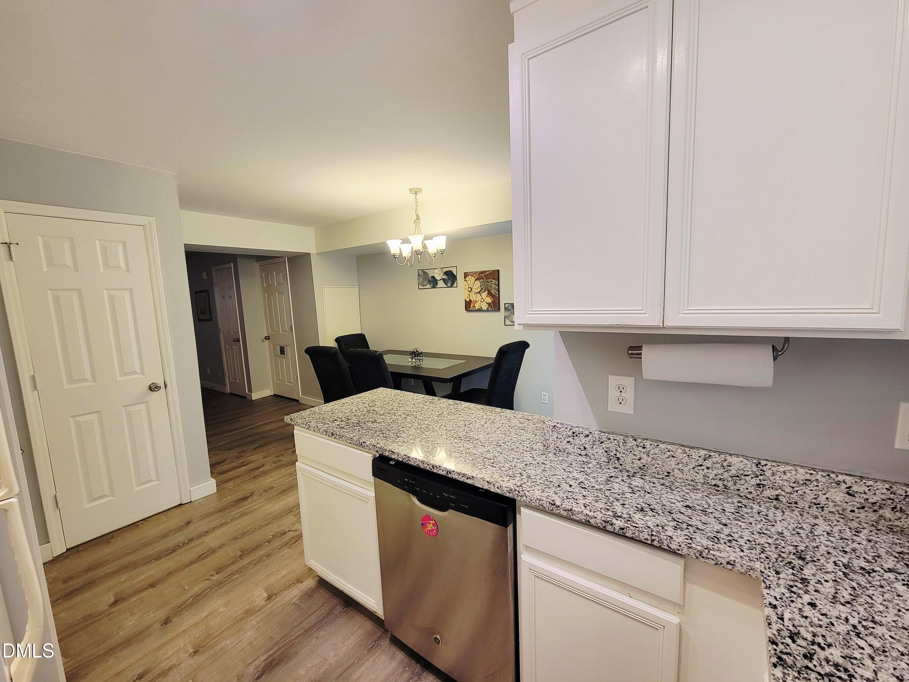 4701 Blue Bird Court Raleigh, NC 27606 - Photo 11 of 42 a kitchen with a sink and cabinets