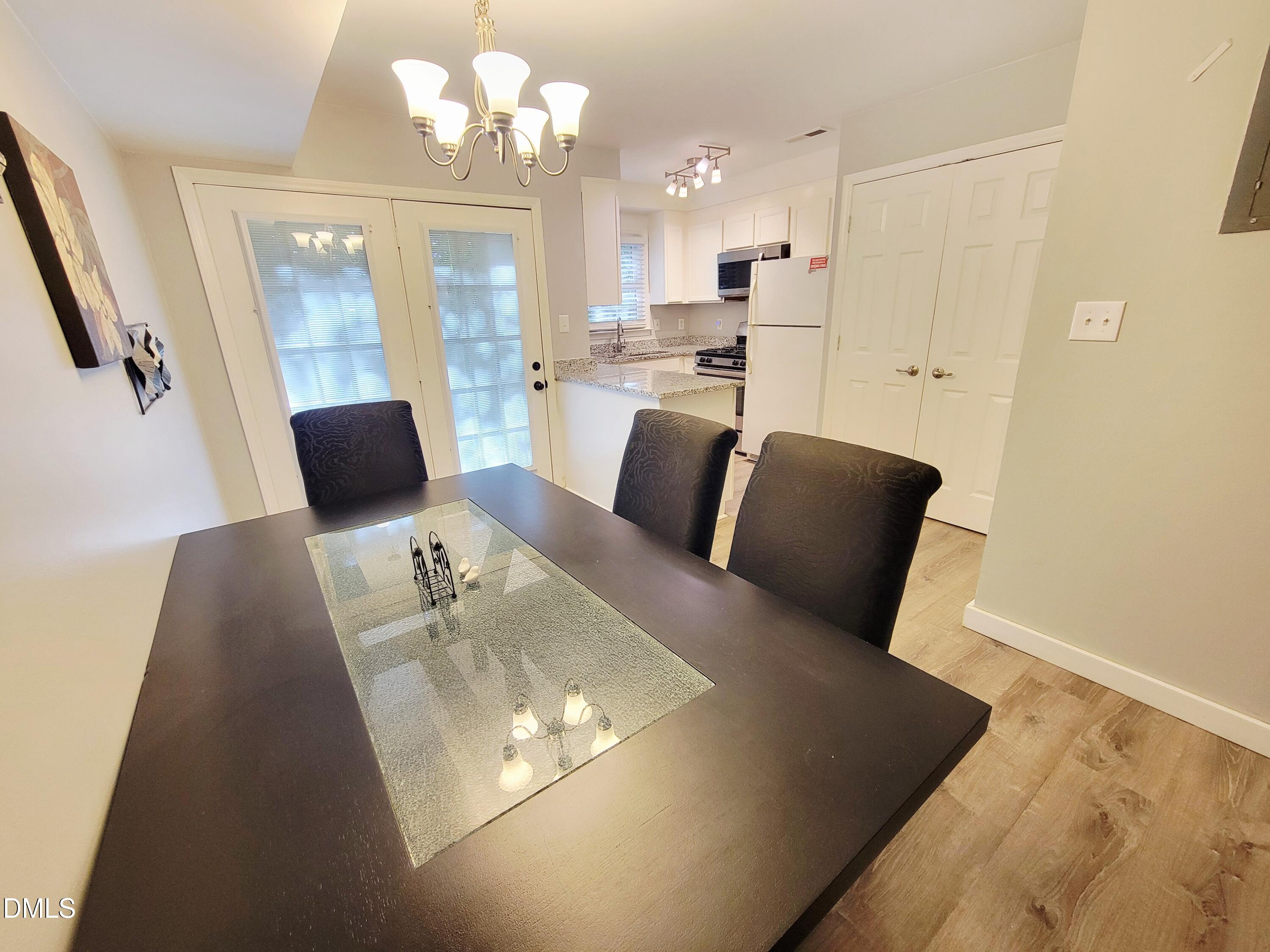 4701 Blue Bird Court Raleigh, NC 27606 - Photo 15 of 42 a living room with furniture and a chandelier