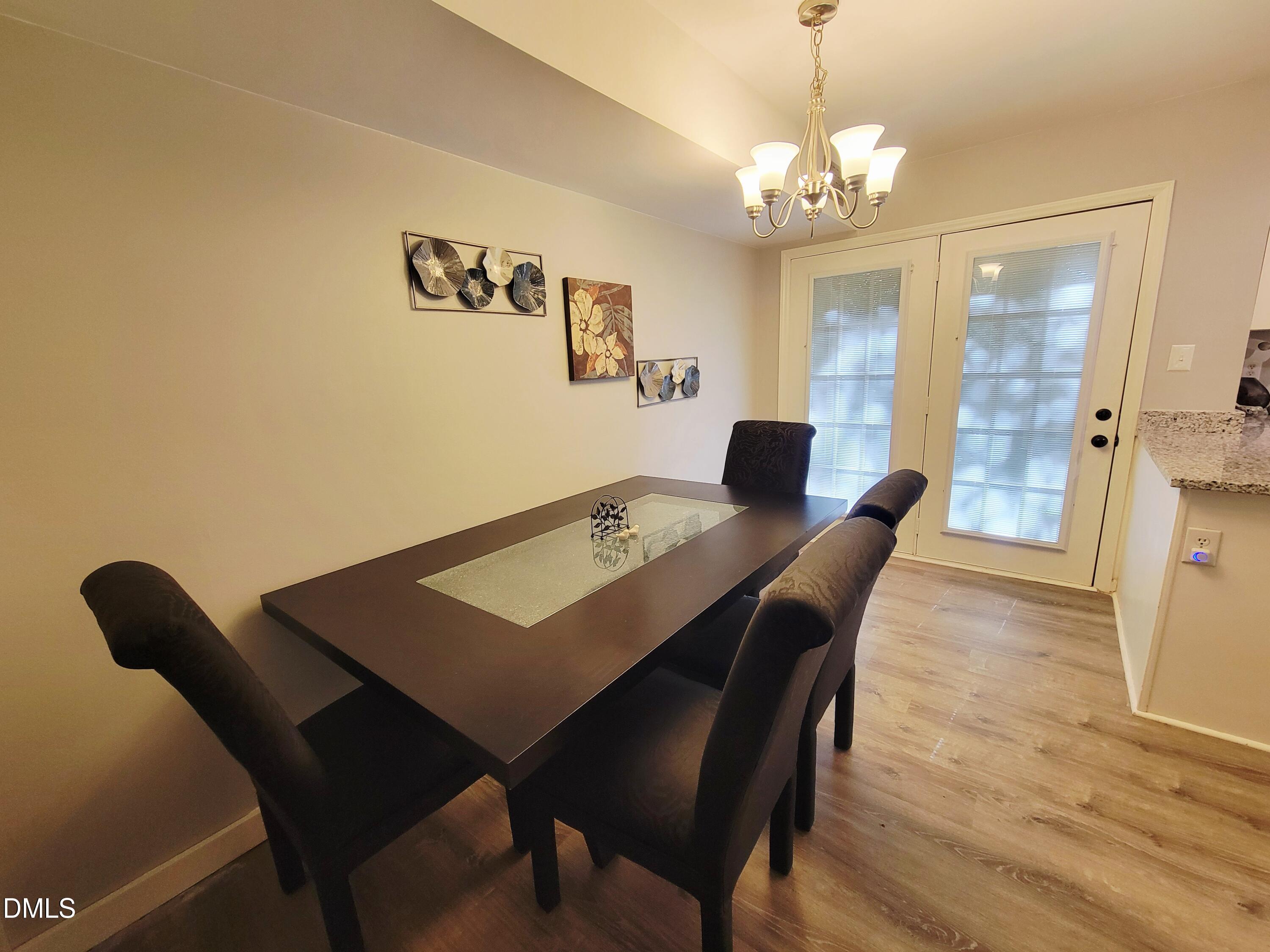 4701 Blue Bird Court Raleigh, NC 27606 - Photo 16 of 42 a view of a dining room with furniture and wooden floor