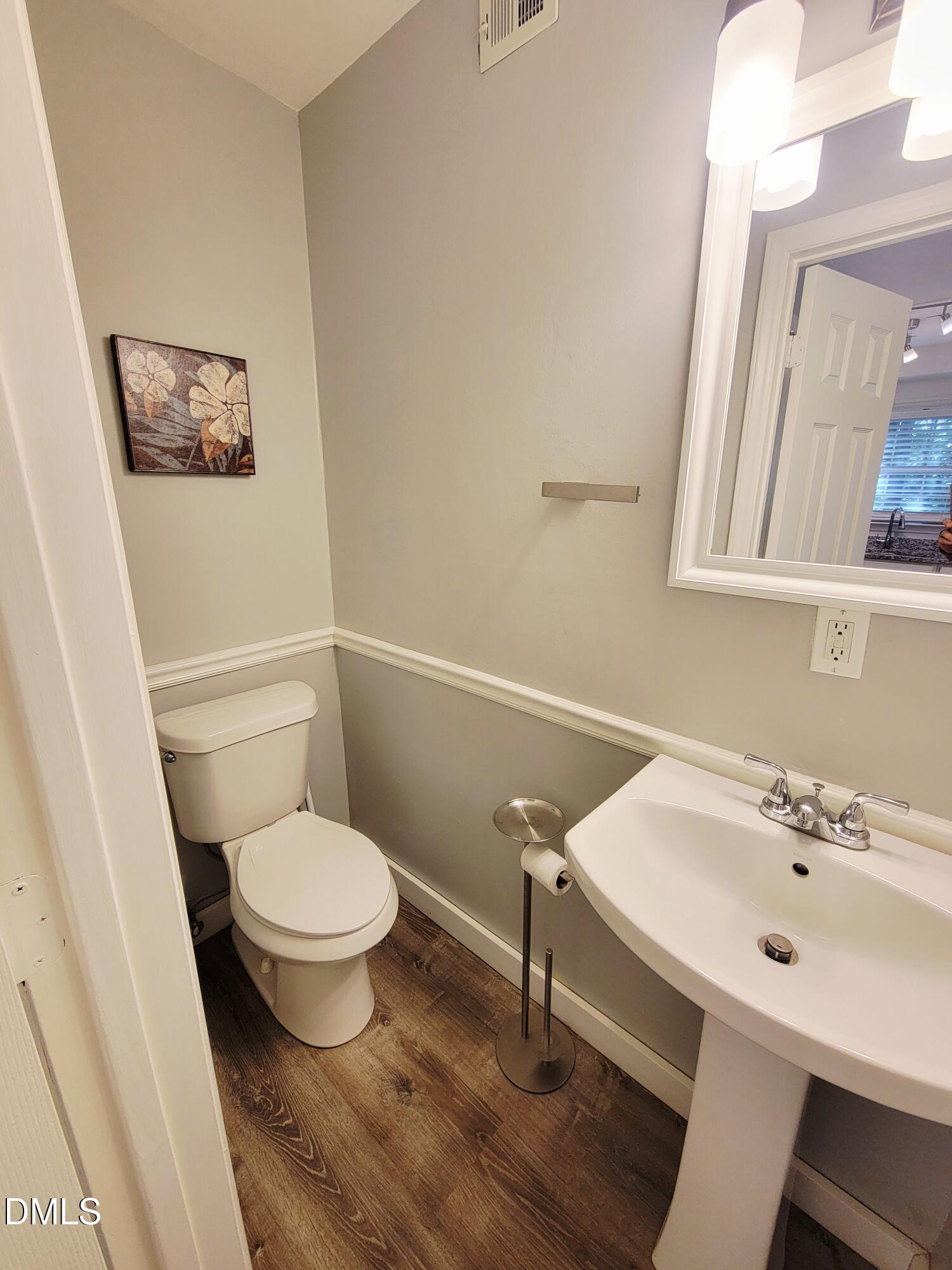 4701 Blue Bird Court Raleigh, NC 27606 - Photo 17 of 42 a bathroom with a sink and a toilet