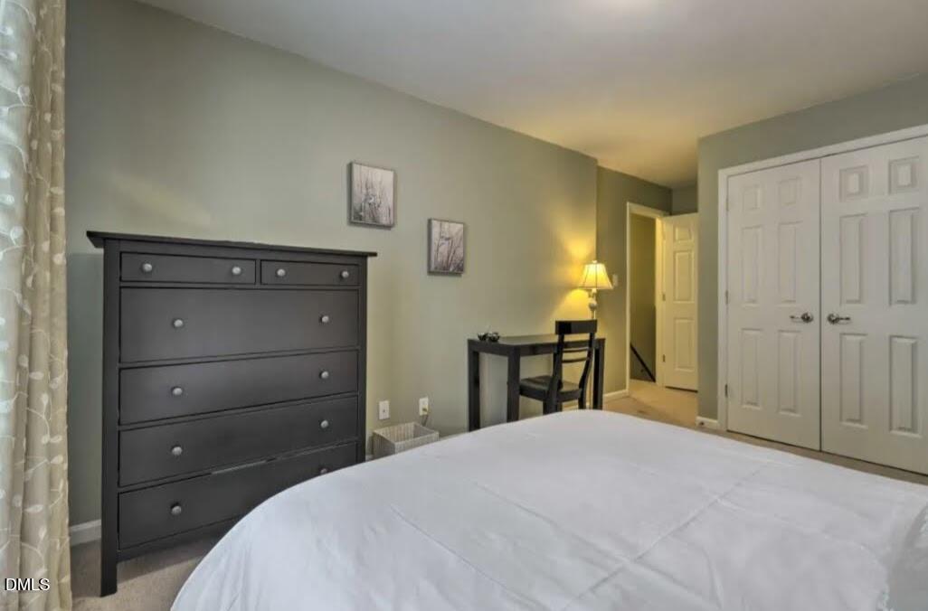 4701 Blue Bird Court Raleigh, NC 27606 - Photo 23 of 42 a bedroom with a bed and a dresser