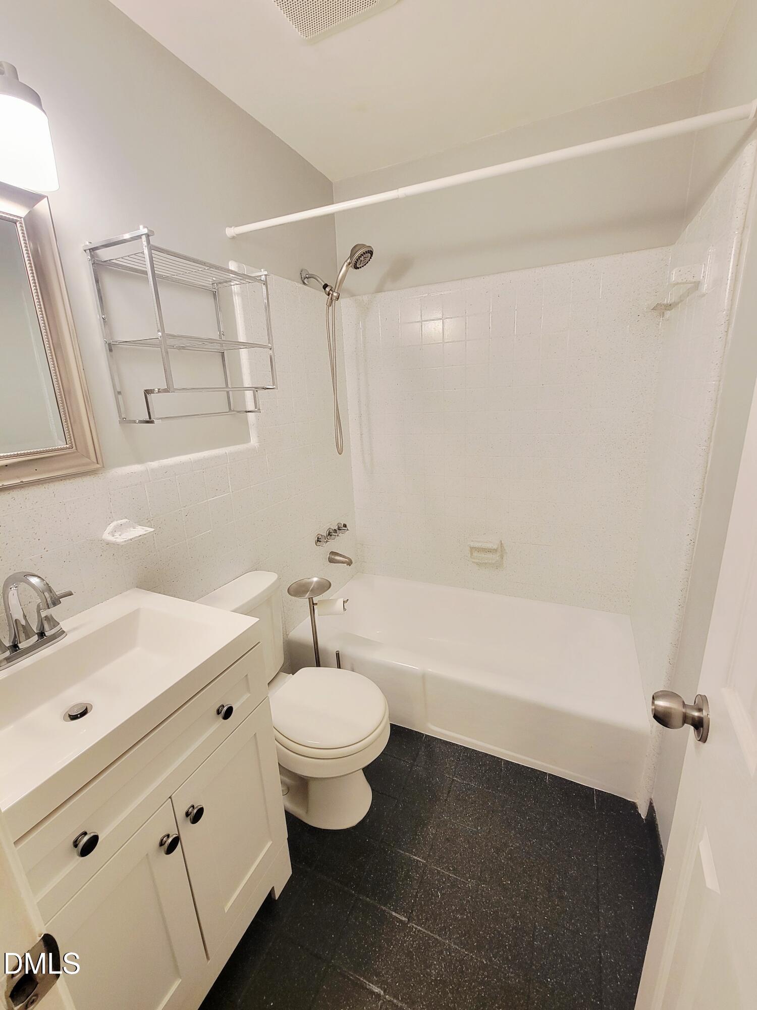 4701 Blue Bird Court Raleigh, NC 27606 - Photo 28 of 42 a bathroom with a sink mirror toilet and bathtub