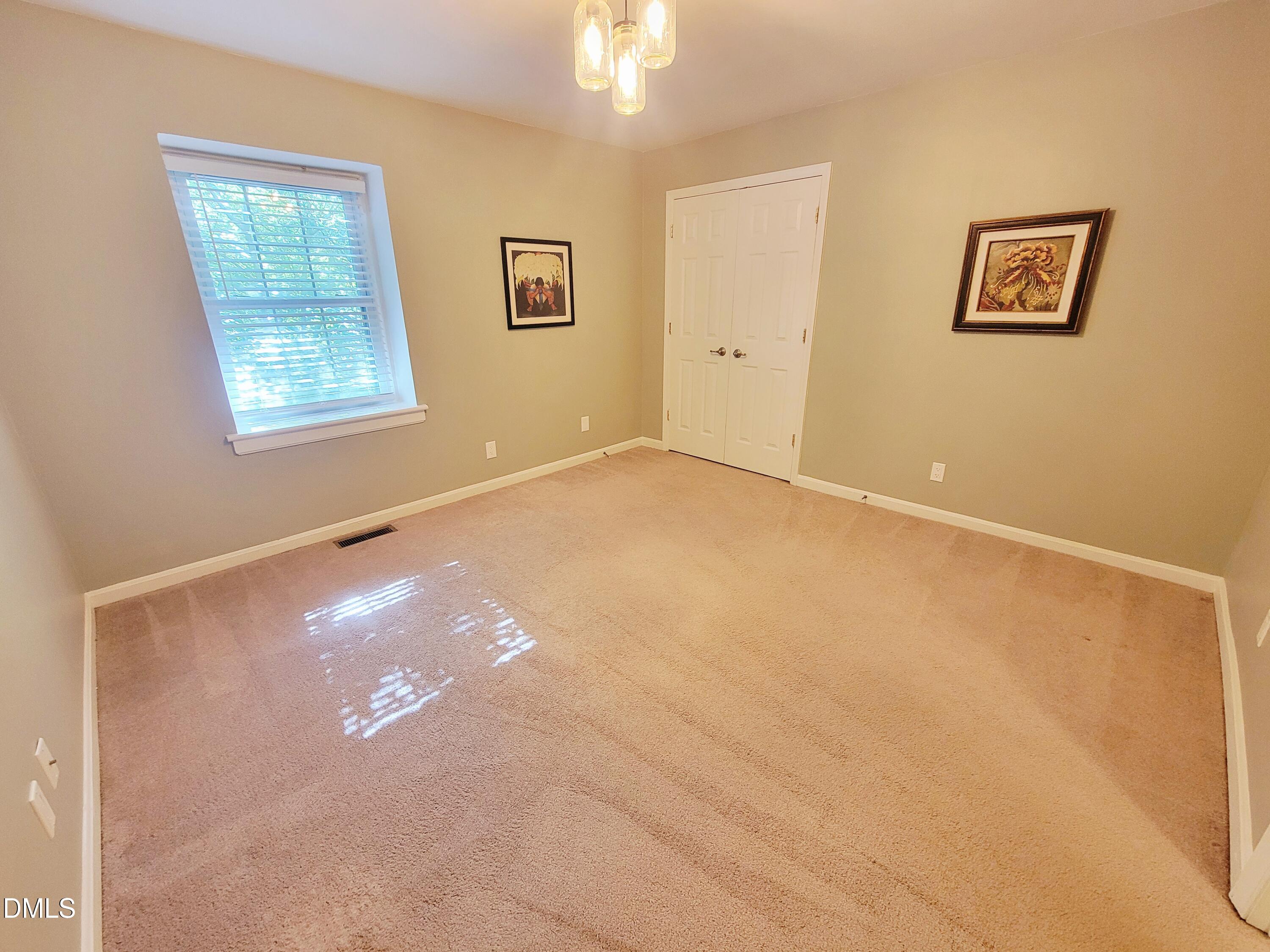 4701 Blue Bird Court Raleigh, NC 27606 - Photo 32 of 42 a view of an empty room with a window