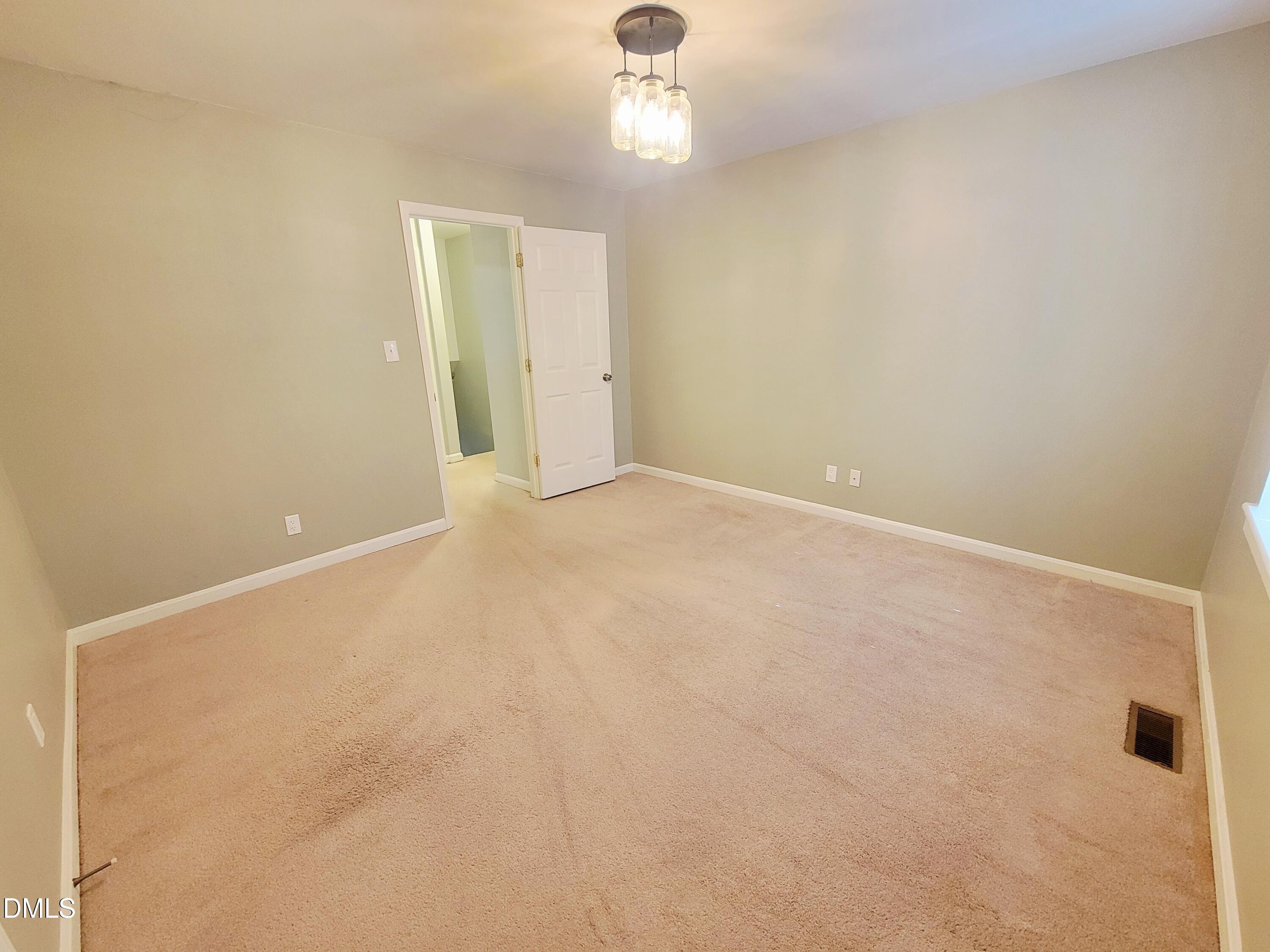 4701 Blue Bird Court Raleigh, NC 27606 - Photo 34 of 42 a view of an empty room with chandelier fan