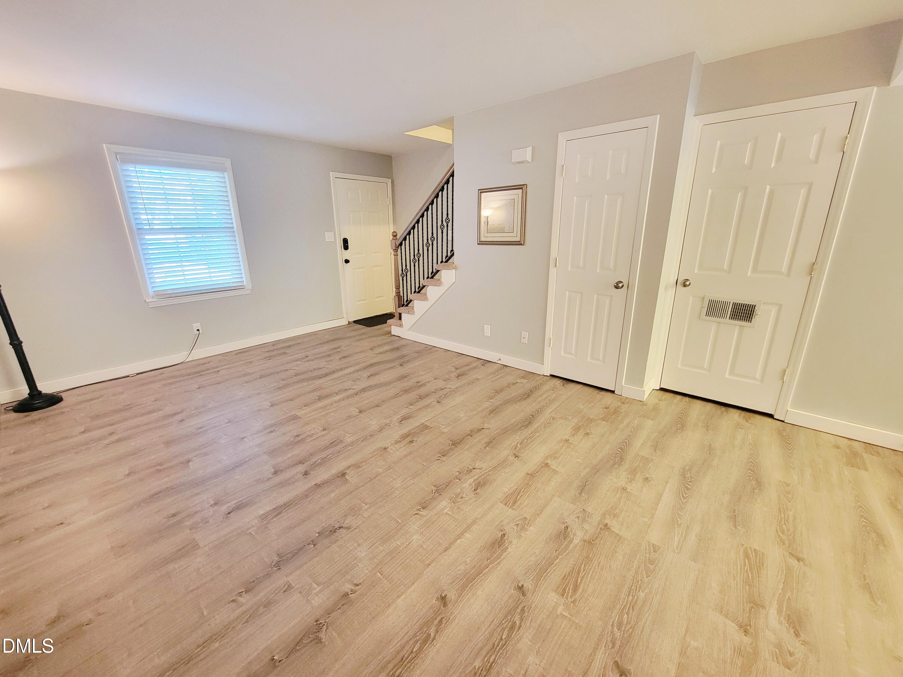 4701 Blue Bird Court Raleigh, NC 27606 - Photo 5 of 42 an empty room with wooden floor and windows
