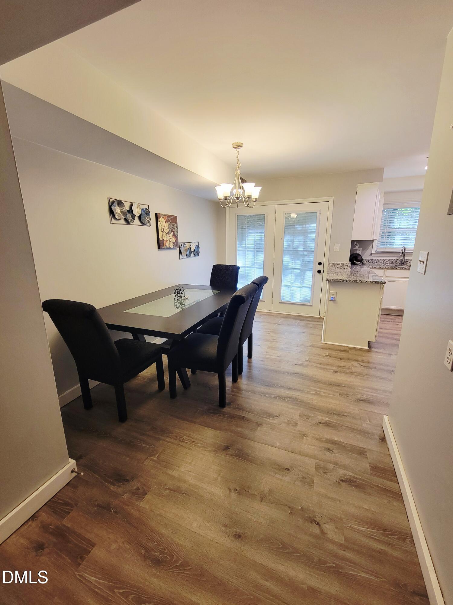 4701 Blue Bird Court Raleigh, NC 27606 - Photo 7 of 42 a view of a dining room with furniture and wooden floor