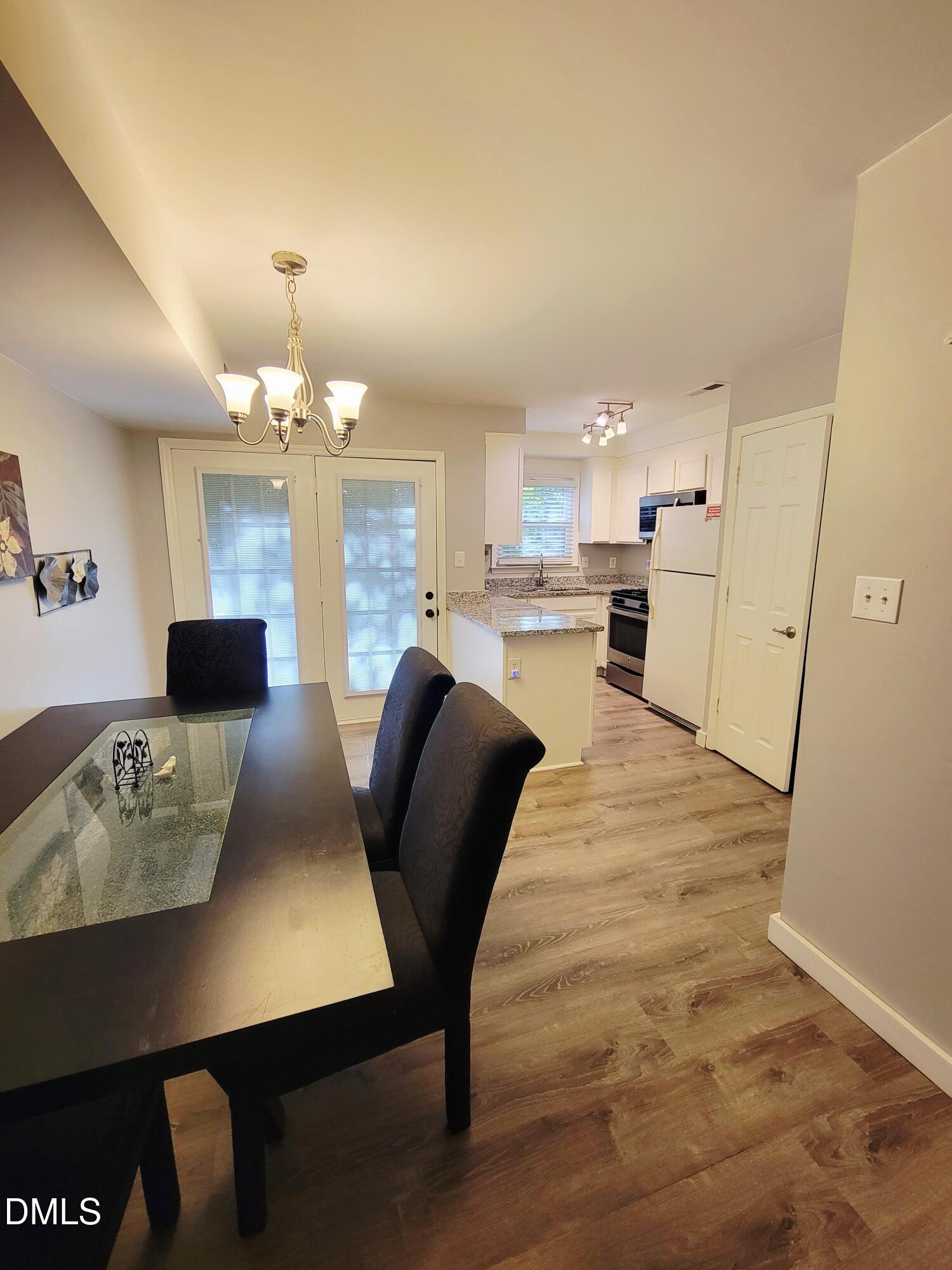 4701 Blue Bird Court Raleigh, NC 27606 - Photo 8 of 42 a view of a dining room with furniture and wooden floor