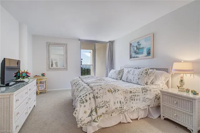 a bedroom with a bed and a flat screen tv in it