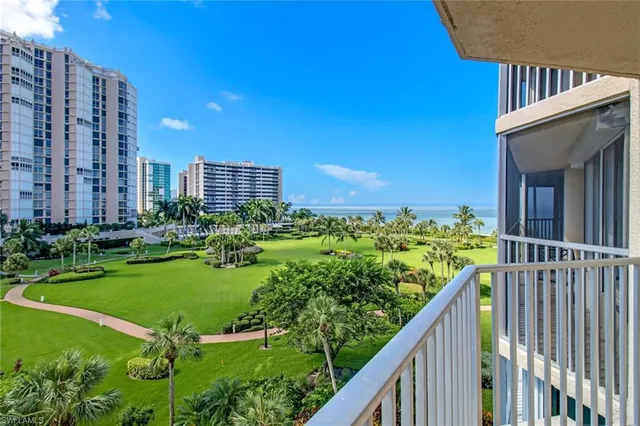 a view of a house with a backyard and trees