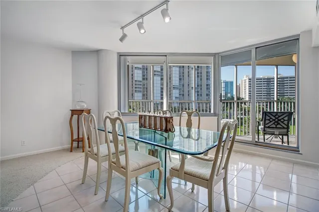 a view of a dining room with furniture large windows and wooden floor