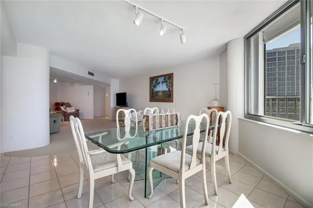 a view of a dining room with furniture and a large window
