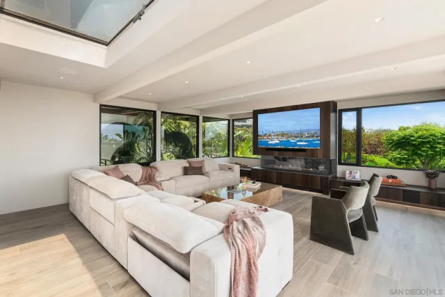 a open kitchen with stainless steel appliances kitchen island granite countertop a refrigerator a stove and a wooden floors