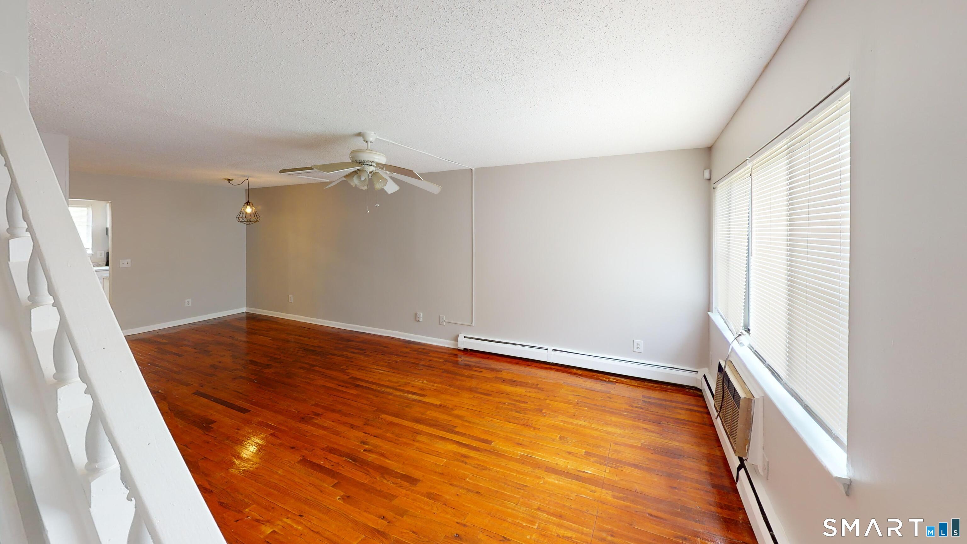 158 High Path Road, Unit 158 Windsor, CT 06095 - Photo 3 of 20 wooden floor in an empty room with a window
