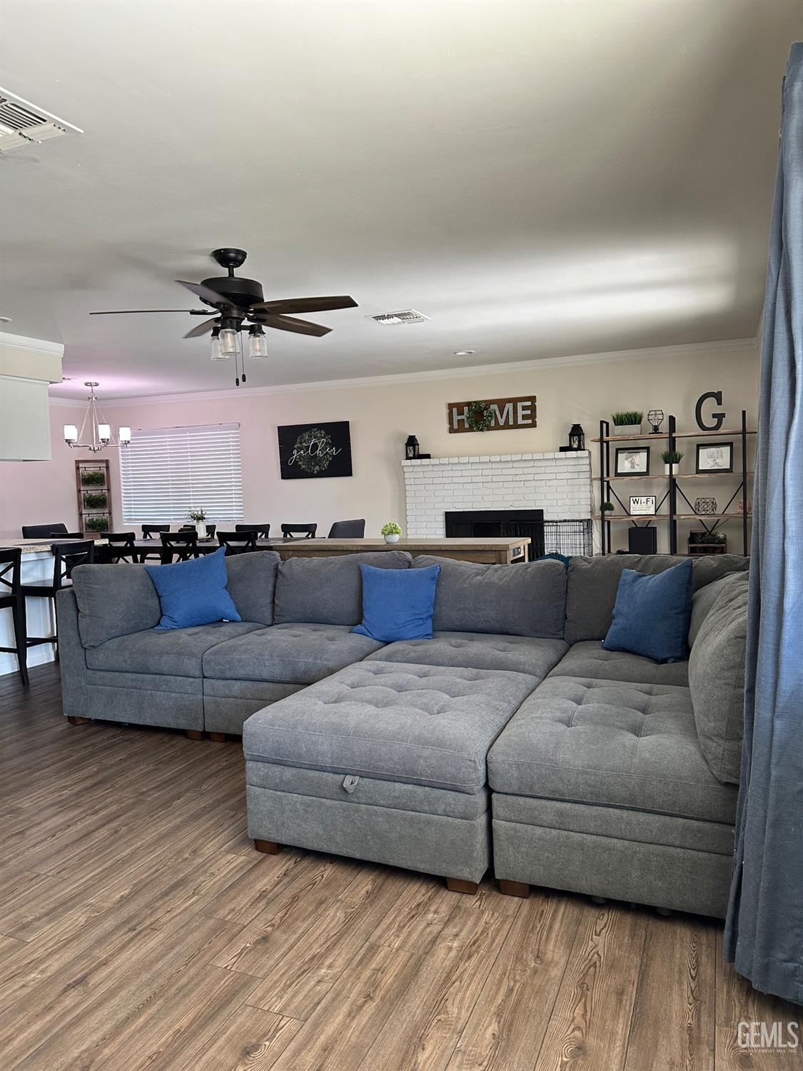 Undisclosed Address Bakersfield, CA 93312 - Photo 11 of 51 a living room with furniture and a wooden floor