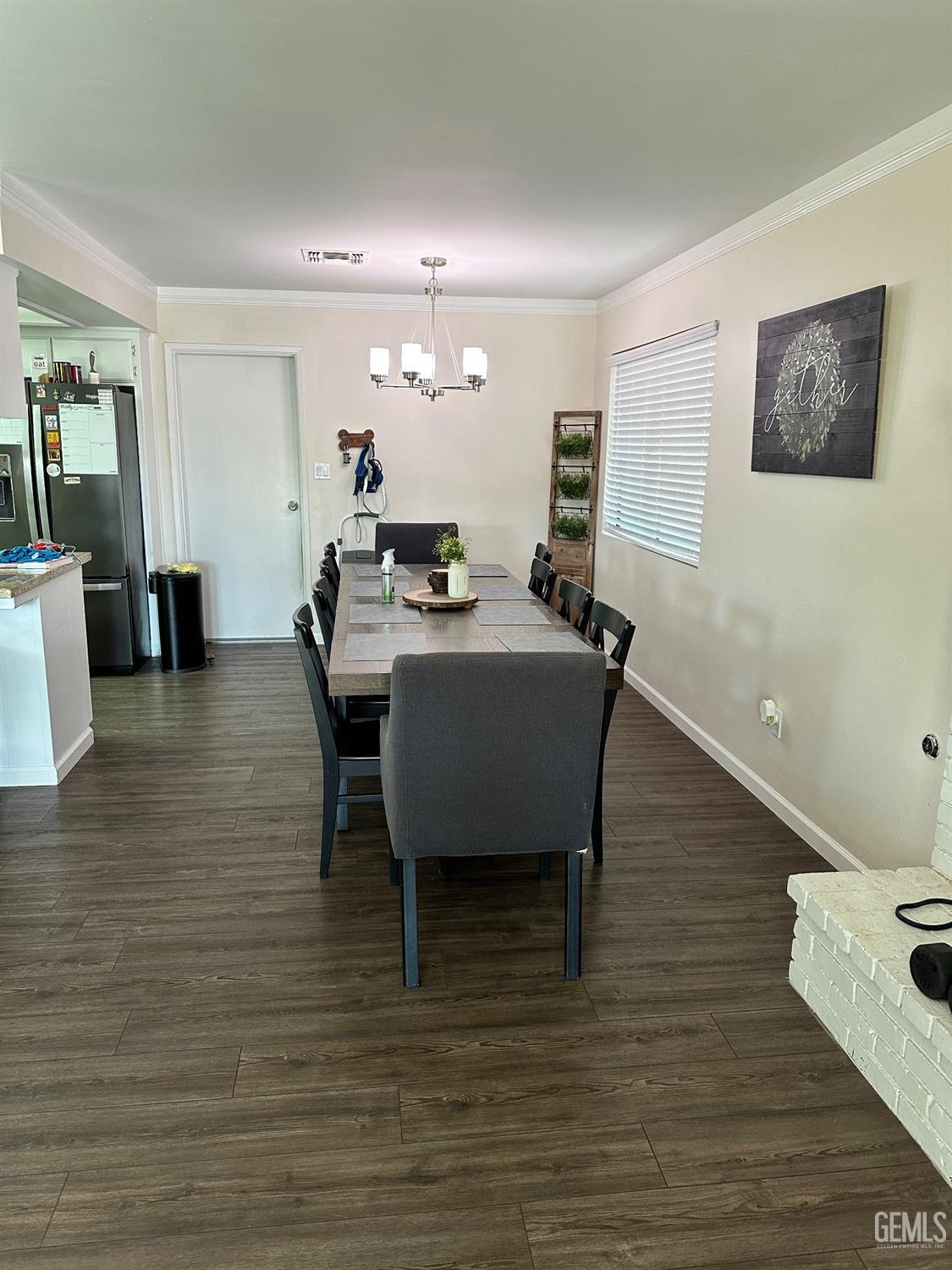 Undisclosed Address Bakersfield, CA 93312 - Photo 16 of 51 a view of a dining room with furniture and wooden floor