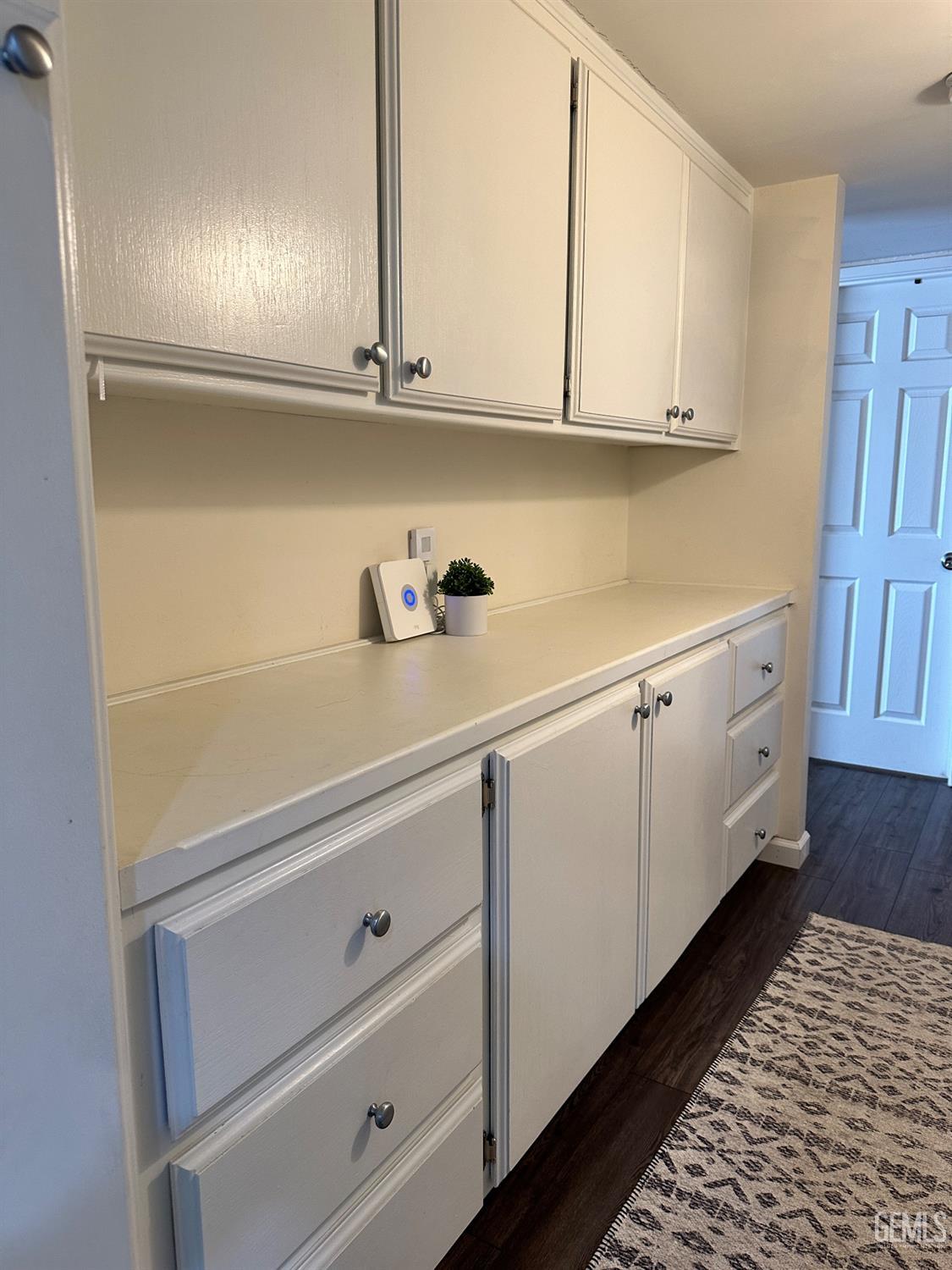 Undisclosed Address Bakersfield, CA 93312 - Photo 18 of 51 a kitchen with cabinets and a wooden floors