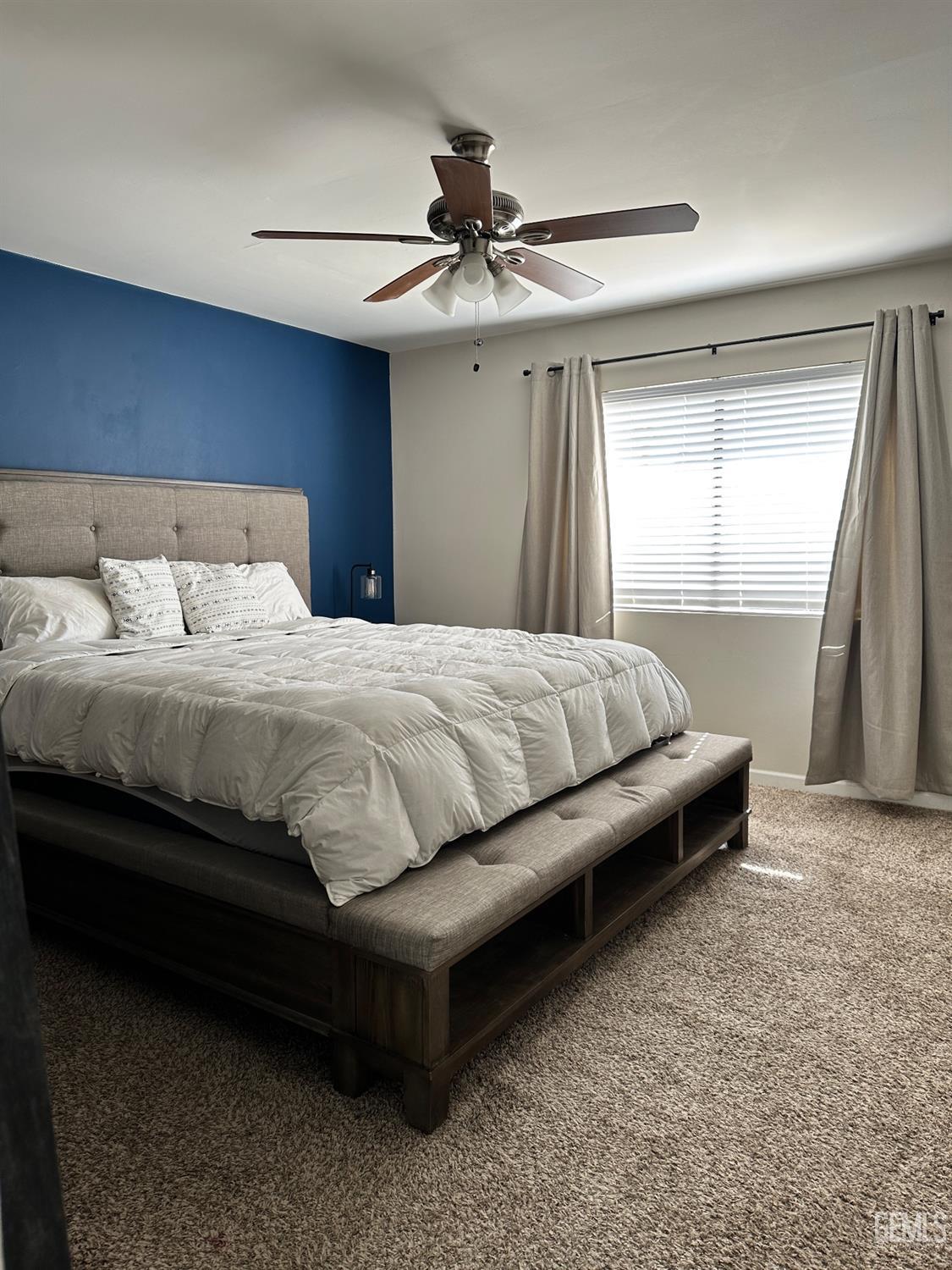 Undisclosed Address Bakersfield, CA 93312 - Photo 19 of 51 a bedroom with a bed and a chandelier