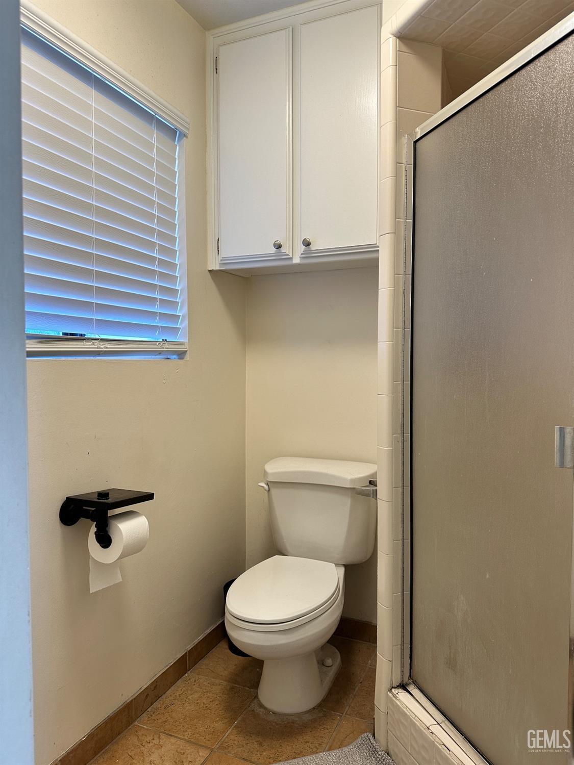 Undisclosed Address Bakersfield, CA 93312 - Photo 25 of 51 a bathroom with a toilet and a window