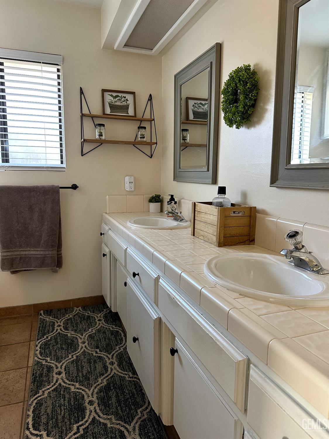 Undisclosed Address Bakersfield, CA 93312 - Photo 27 of 51 a bathroom with a double vanity sink mirror and