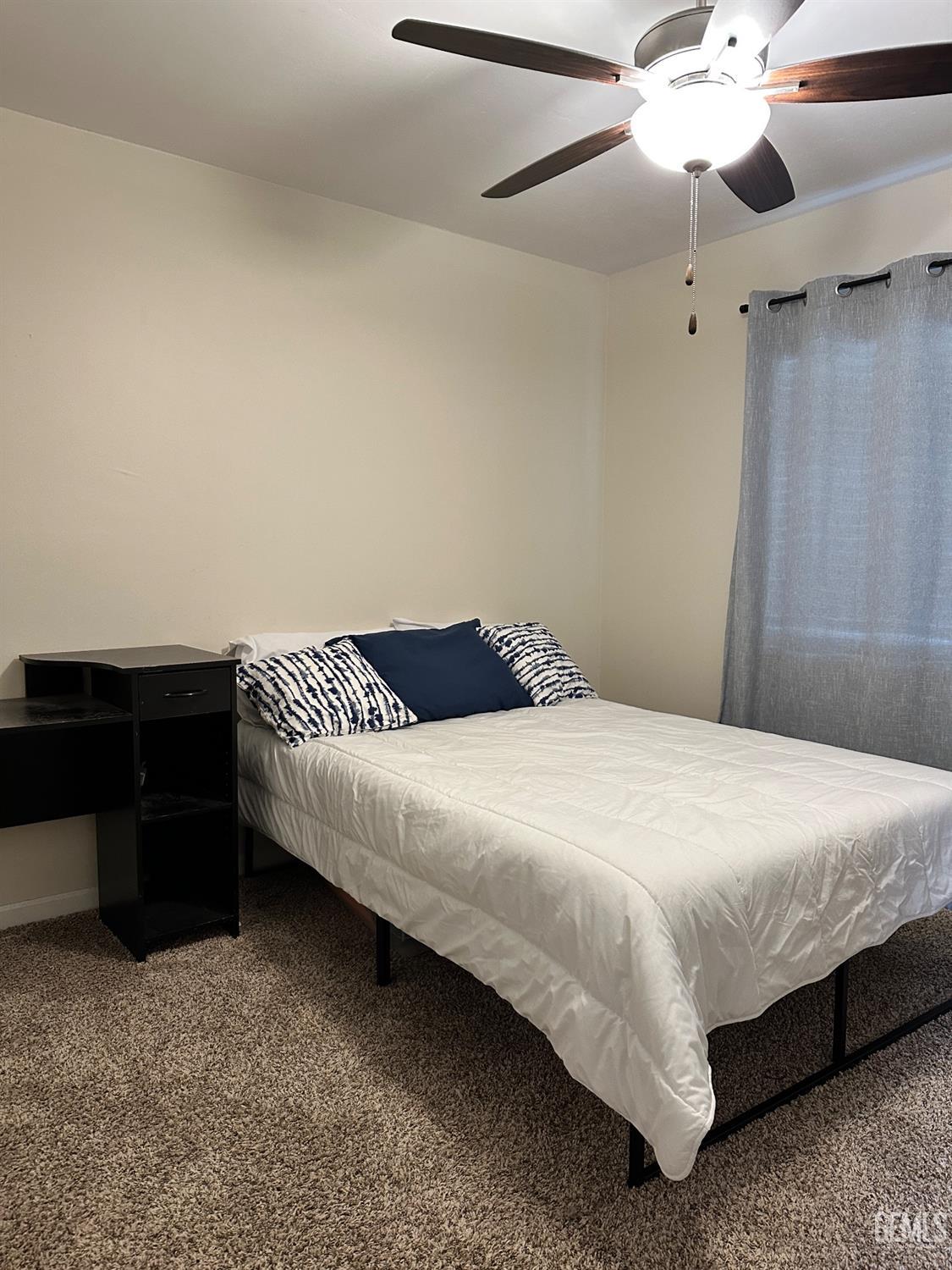 Undisclosed Address Bakersfield, CA 93312 - Photo 30 of 51 a bedroom with a bed and a chandelier