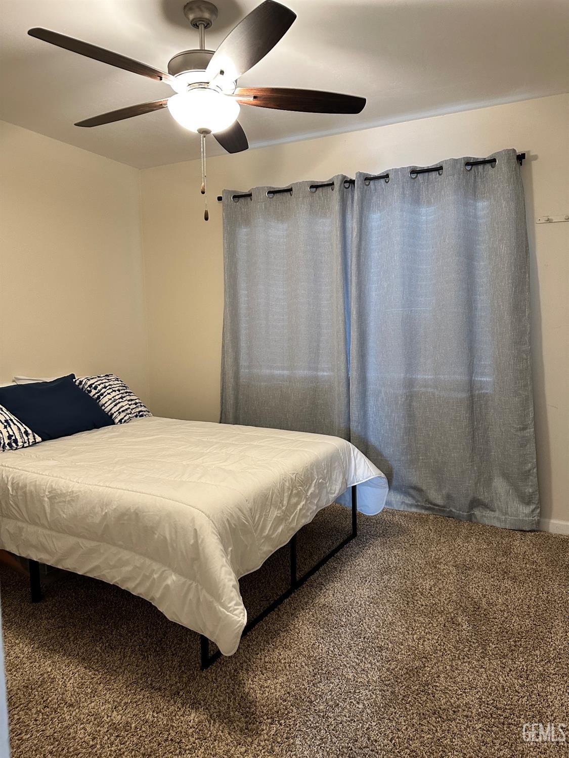 Undisclosed Address Bakersfield, CA 93312 - Photo 31 of 51 a bedroom with a bed and a chandelier