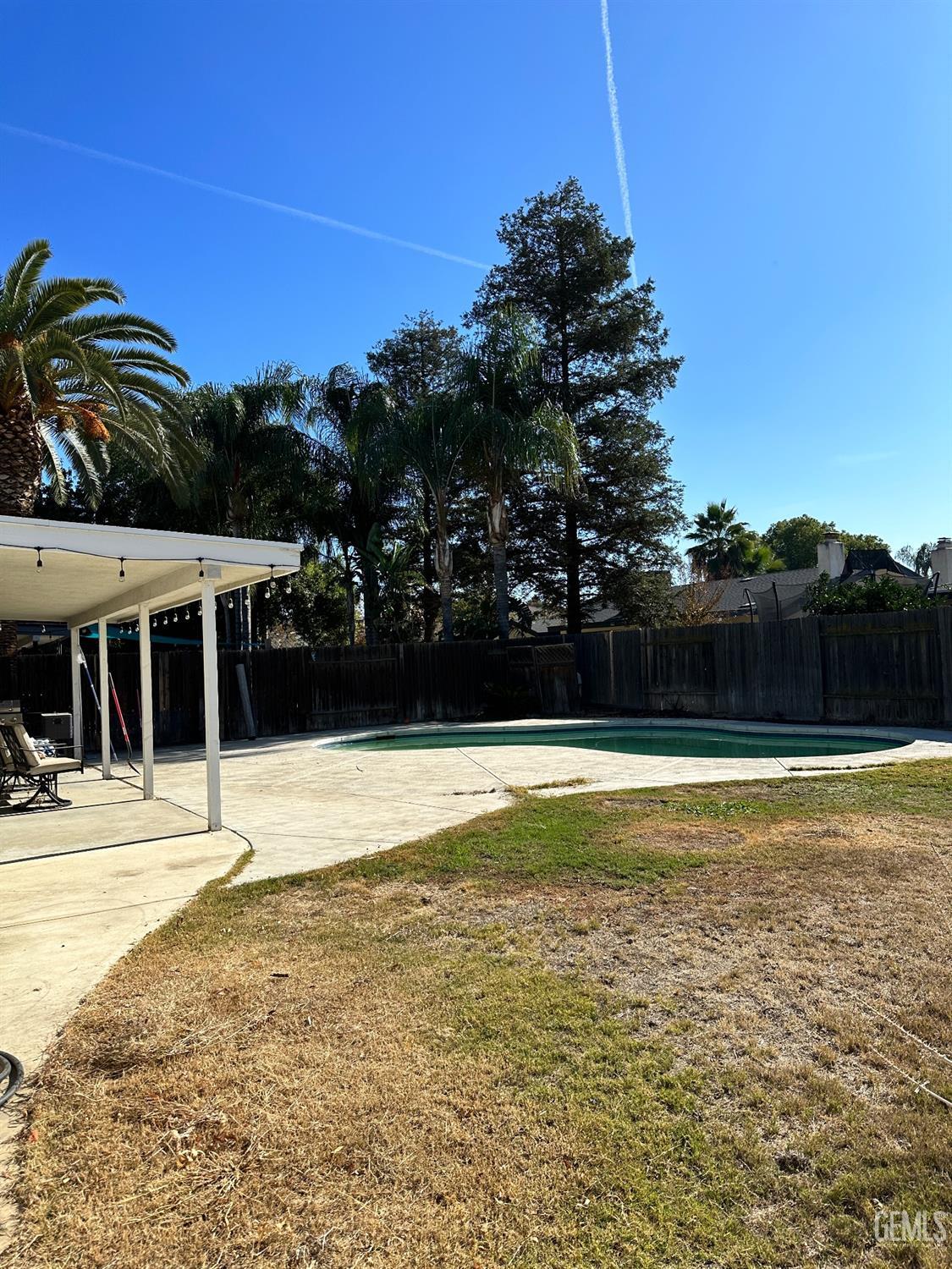 Undisclosed Address Bakersfield, CA 93312 - Photo 40 of 51 a view of a swimming pool with an outdoor space and seating area