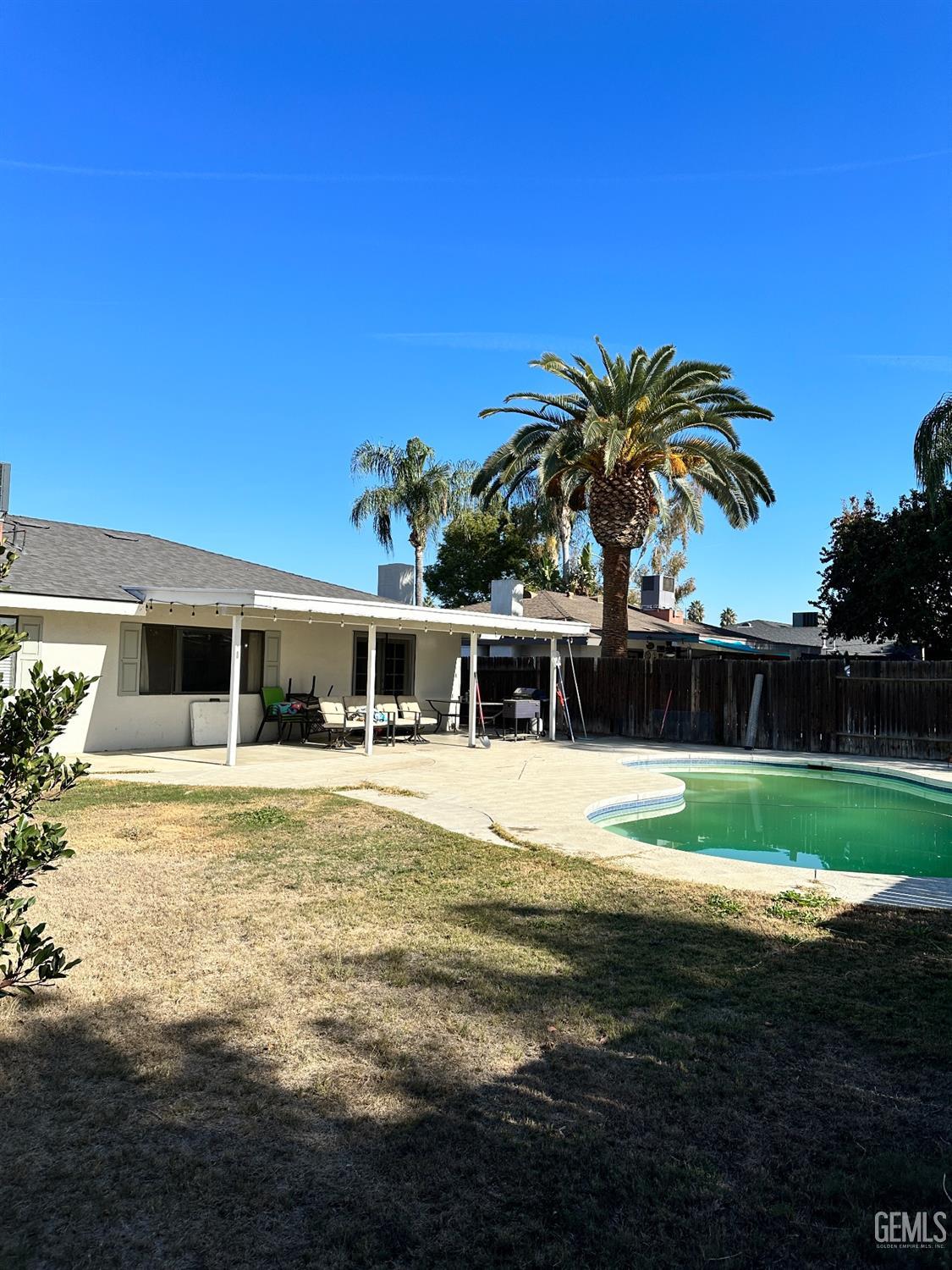 Undisclosed Address Bakersfield, CA 93312 - Photo 46 of 51 a big house with a big yard and palm trees