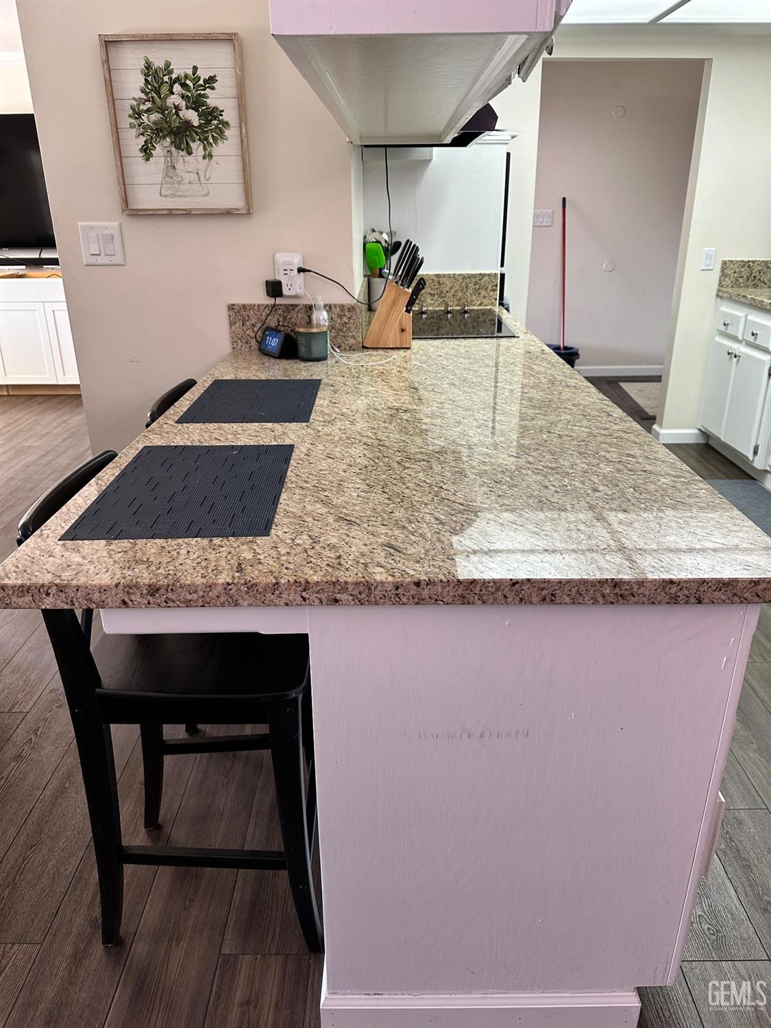 Undisclosed Address Bakersfield, CA 93312 - Photo 49 of 51 a view of a kitchen area with furniture and wooden floor