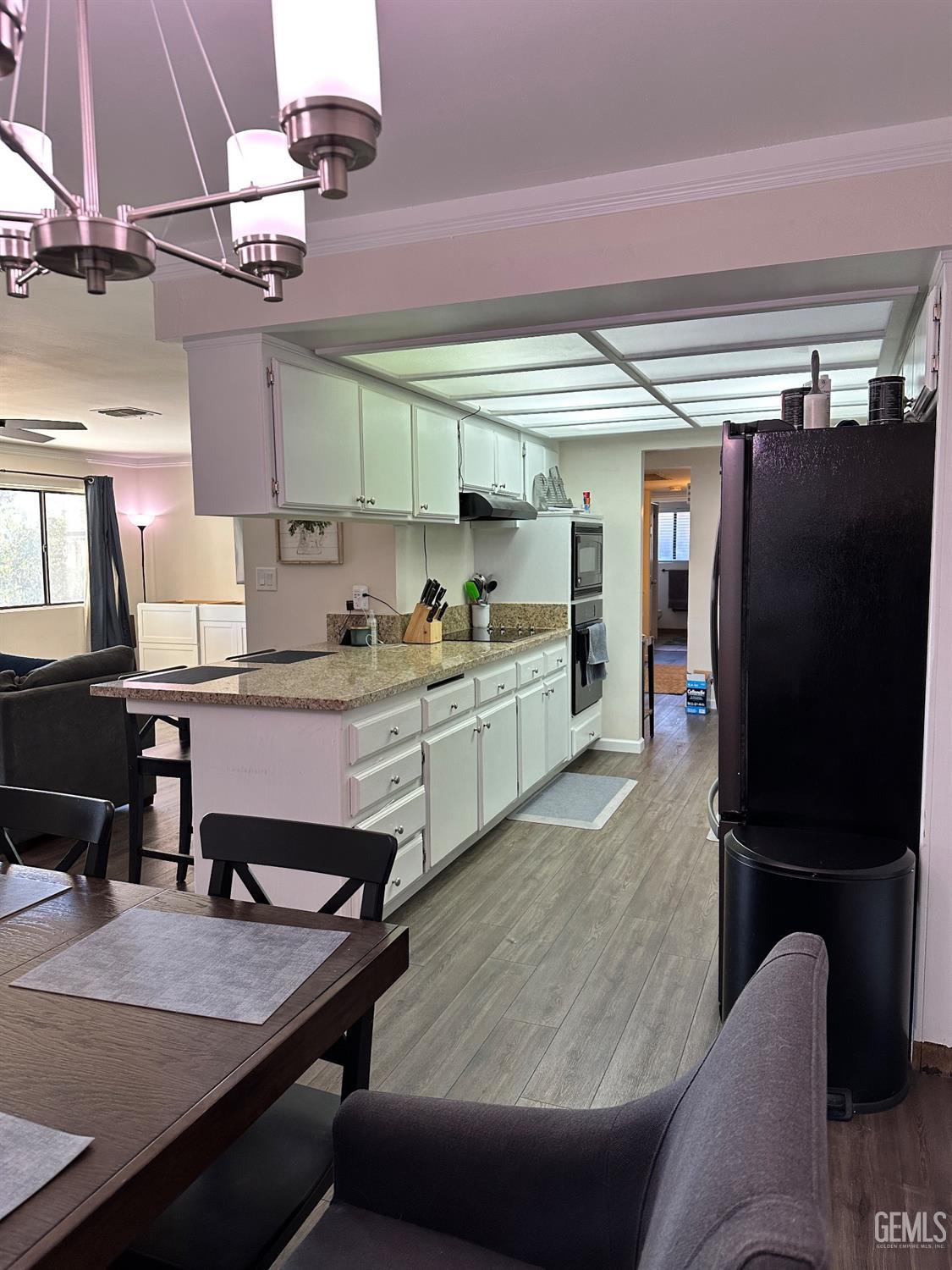 Undisclosed Address Bakersfield, CA 93312 - Photo 5 of 51 a living room with stainless steel appliances kitchen island granite countertop furniture and a refrigerator