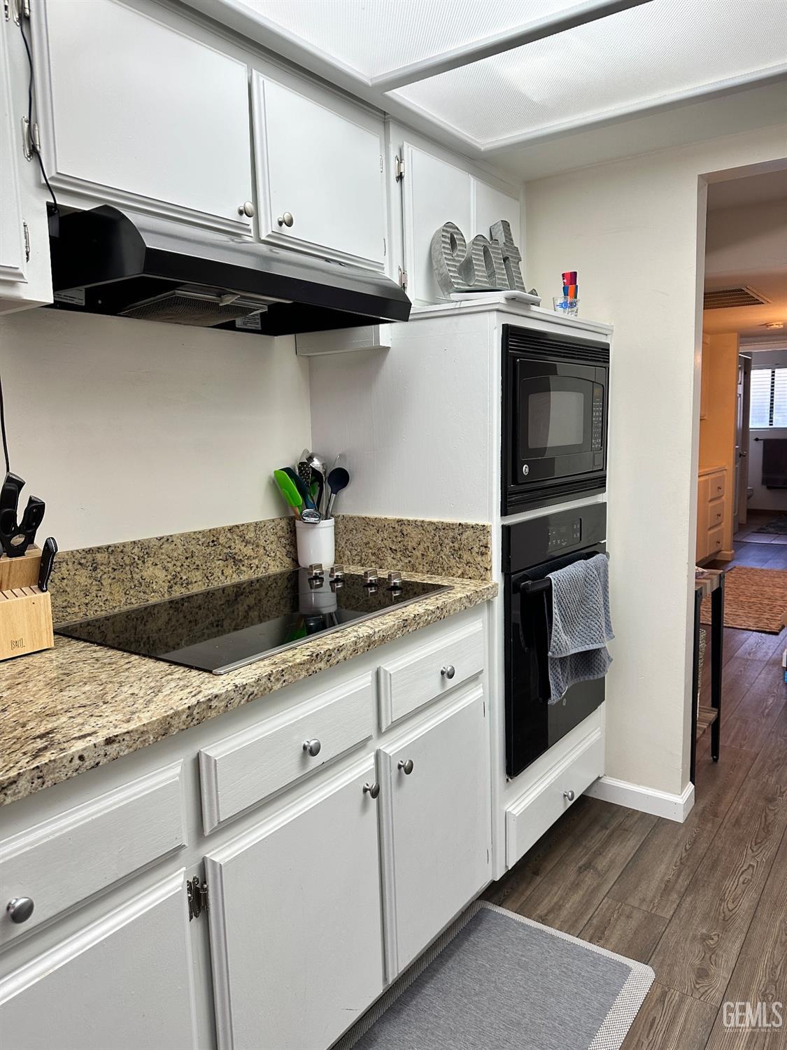 Undisclosed Address Bakersfield, CA 93312 - Photo 7 of 51 a kitchen with granite countertop cabinets and steel stainless steel appliances