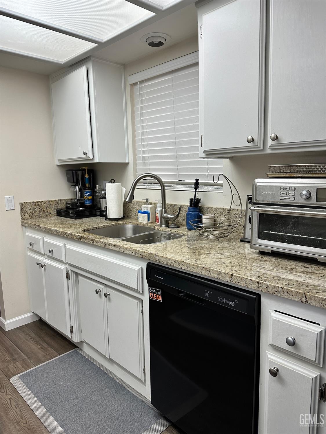 Undisclosed Address Bakersfield, CA 93312 - Photo 8 of 51 a kitchen with granite countertop a sink a stove and cabinets