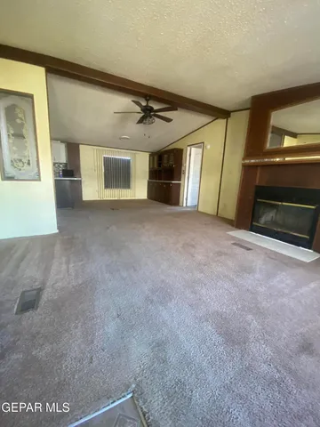 a view of empty room with a fireplace