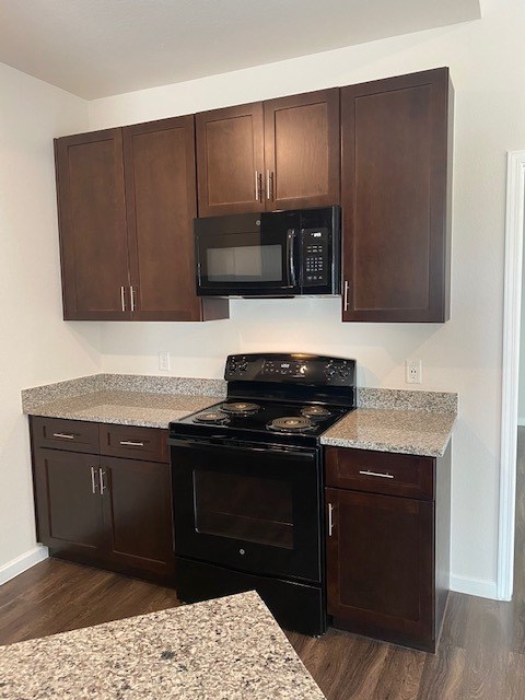 6707 Morgan Road, Unit 32 Greenwell Springs, LA 70739 - Photo 6 of 7 a kitchen with stainless steel appliances granite countertop a stove and a microwave