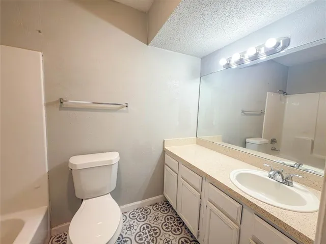 a bathroom with a sink toilet and a mirror