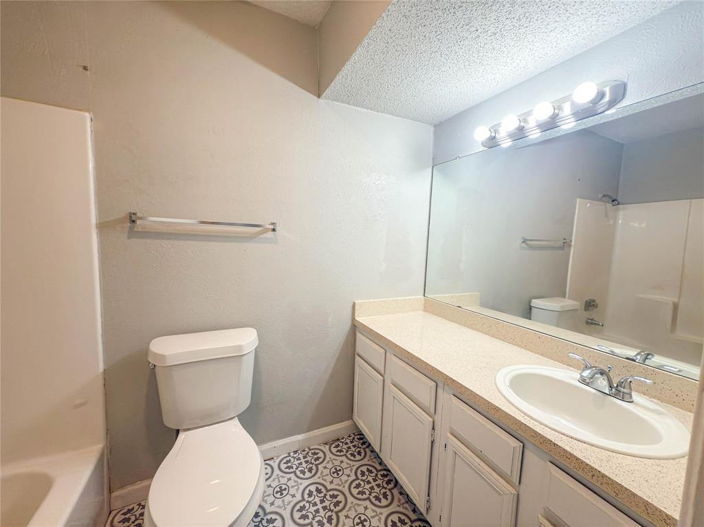 9696 Walnut Street, Unit 2108 Dallas, TX 75243 - Photo 17 of 21 a bathroom with a sink toilet and a mirror