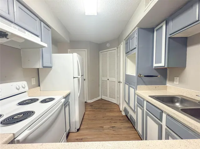 a kitchen that has a sink and a stove