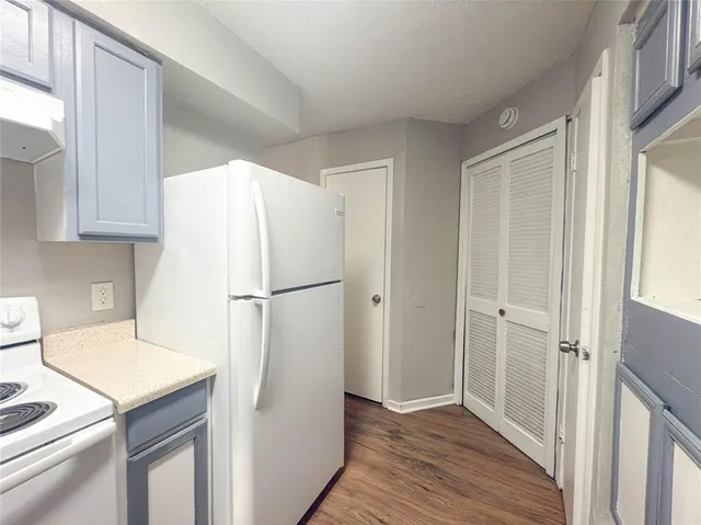 a white refrigerator freezer sitting inside of a kitchen