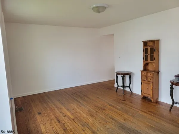 a view of a room with wooden floor and a sink