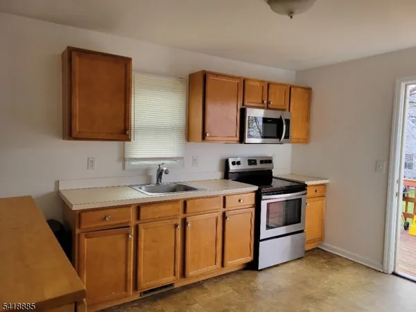 a kitchen with a stove and a sink