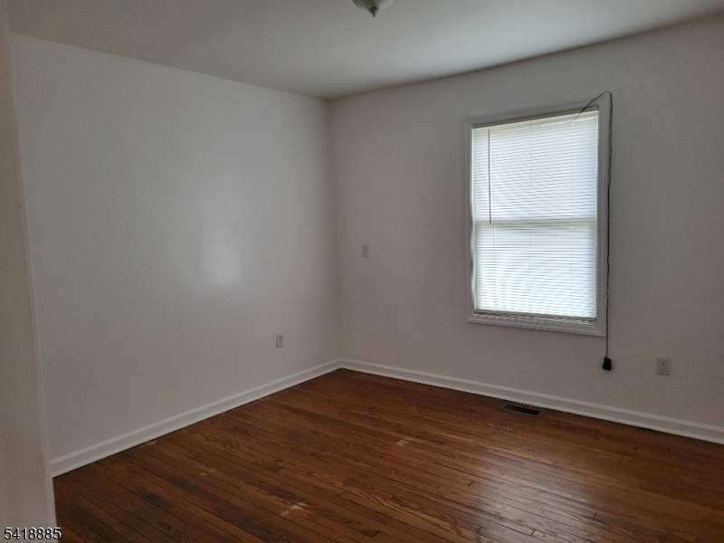 403 Highway 202, Unit B Raritan, NJ 08869 - Photo 6 of 9 wooden floor in an empty room with a window
