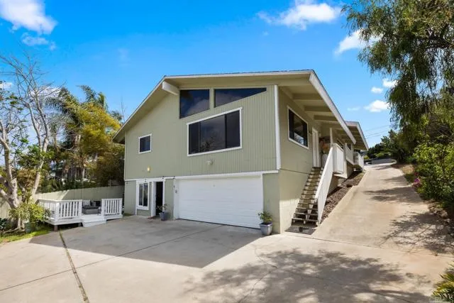 601 Neptune Avenue Encinitas, CA 92024 - Photo 27 of 36 a front view of a house with a yard