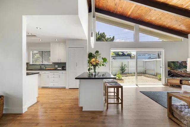 a kitchen with stainless steel appliances kitchen island granite countertop a table and chairs in it