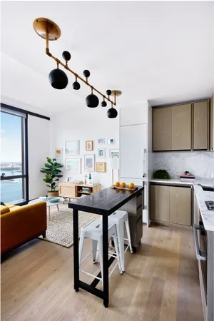 a kitchen with stainless steel appliances kitchen island granite countertop a sink and a stove