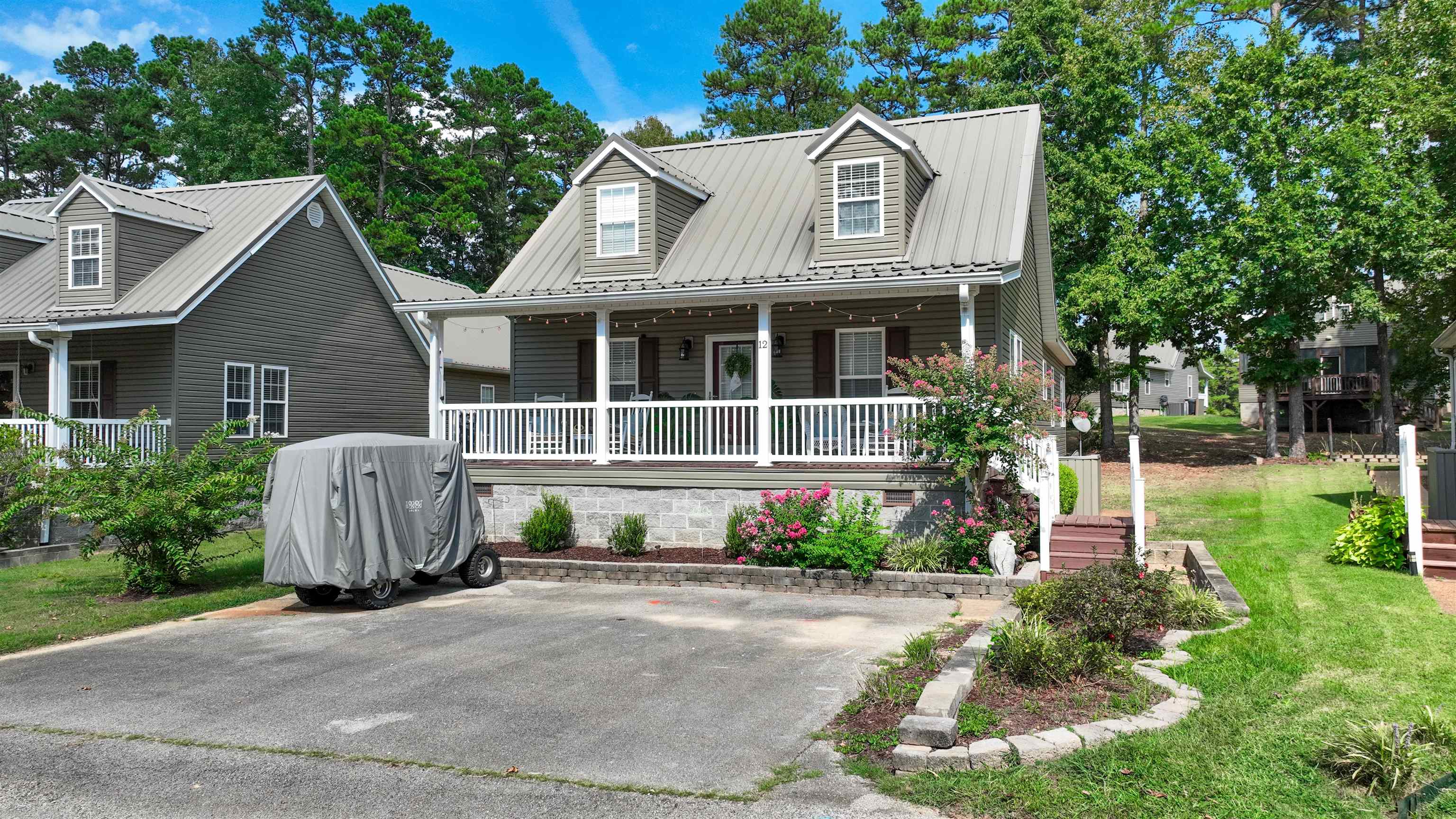 a front view of a house with a garden and plants