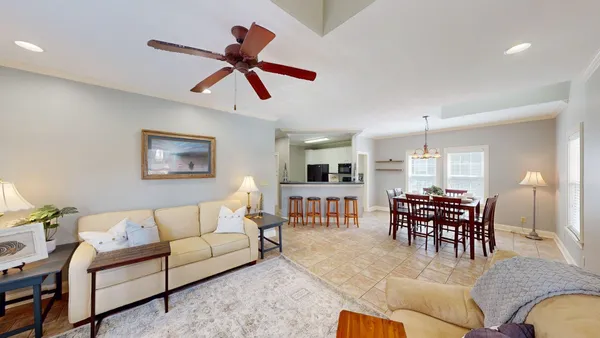 a living room with furniture and kitchen view