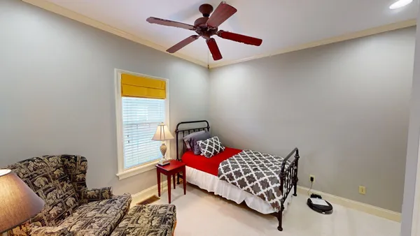 a bedroom with a bed and window