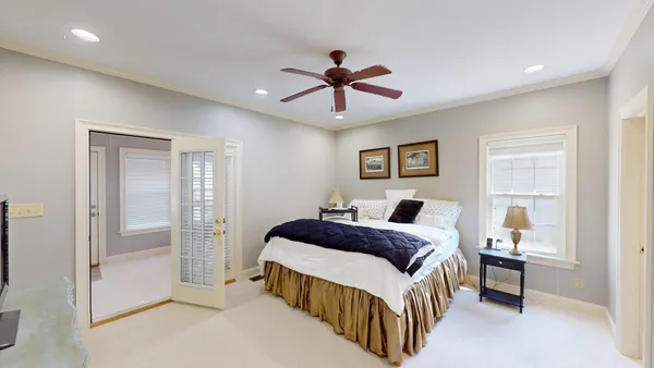 a bedroom with a bed and a chandelier