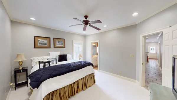 a bedroom with a bed and a chandelier