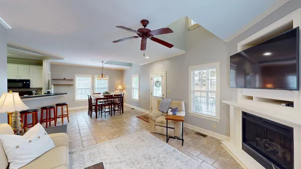 a living room with furniture a fireplace and a flat screen tv