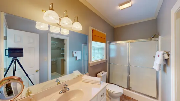 a bathroom with a sink a toilet and shower